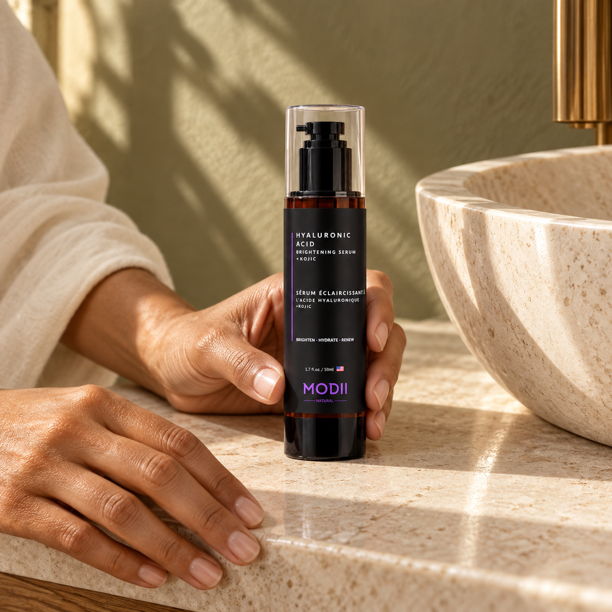 MODII Natural Hyaluronic Acid Brightening Serum + Kojic - 50ml — product shown in adult hands for scale