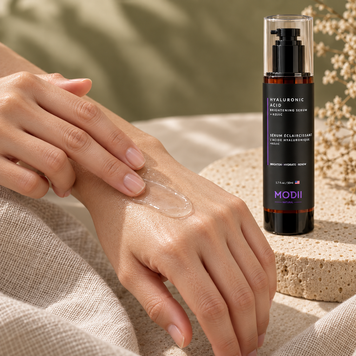 MODII Natural Hyaluronic Acid Brightening Serum + Kojic - 50ml — adult demonstrating application to skin