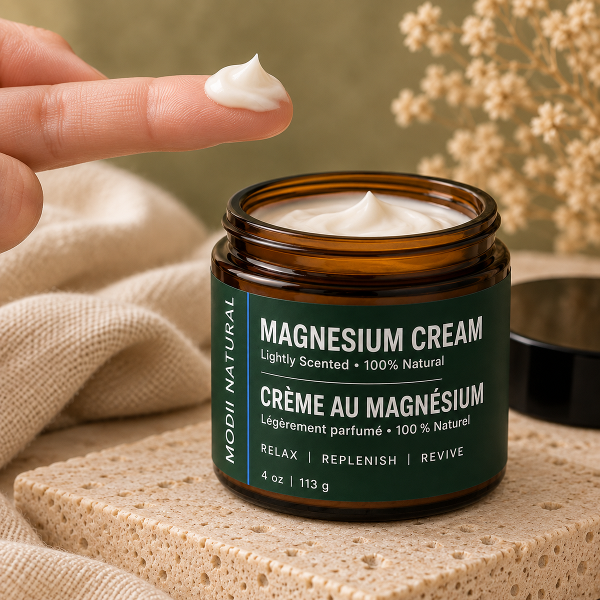 MODII Natural Magnesium Body Cream, Lemongrass - 113g — a small amount prepared on adult fingertips before application