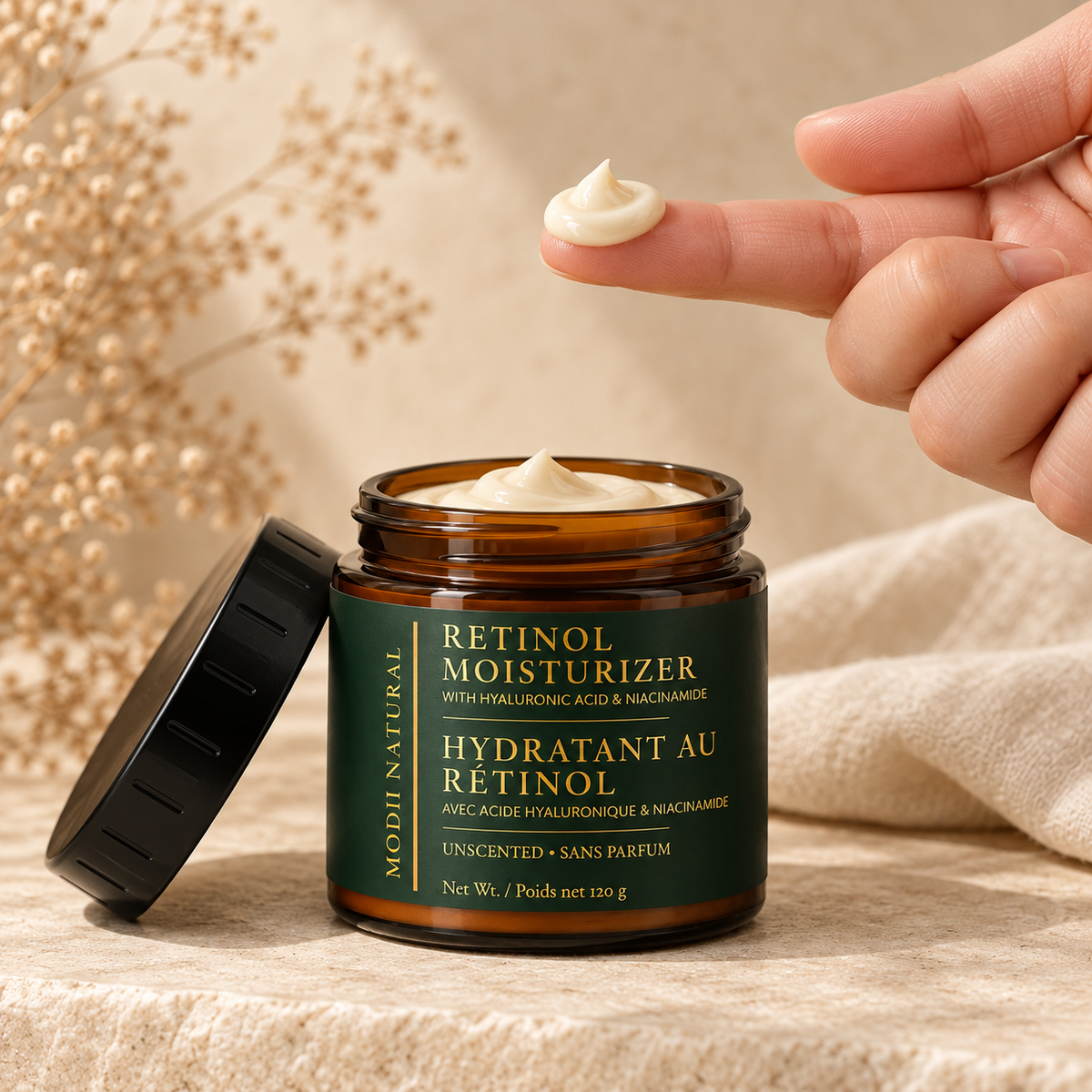 MODII Natural Retinol Face Moisturizer - 120g — a small amount prepared on adult fingertips before application