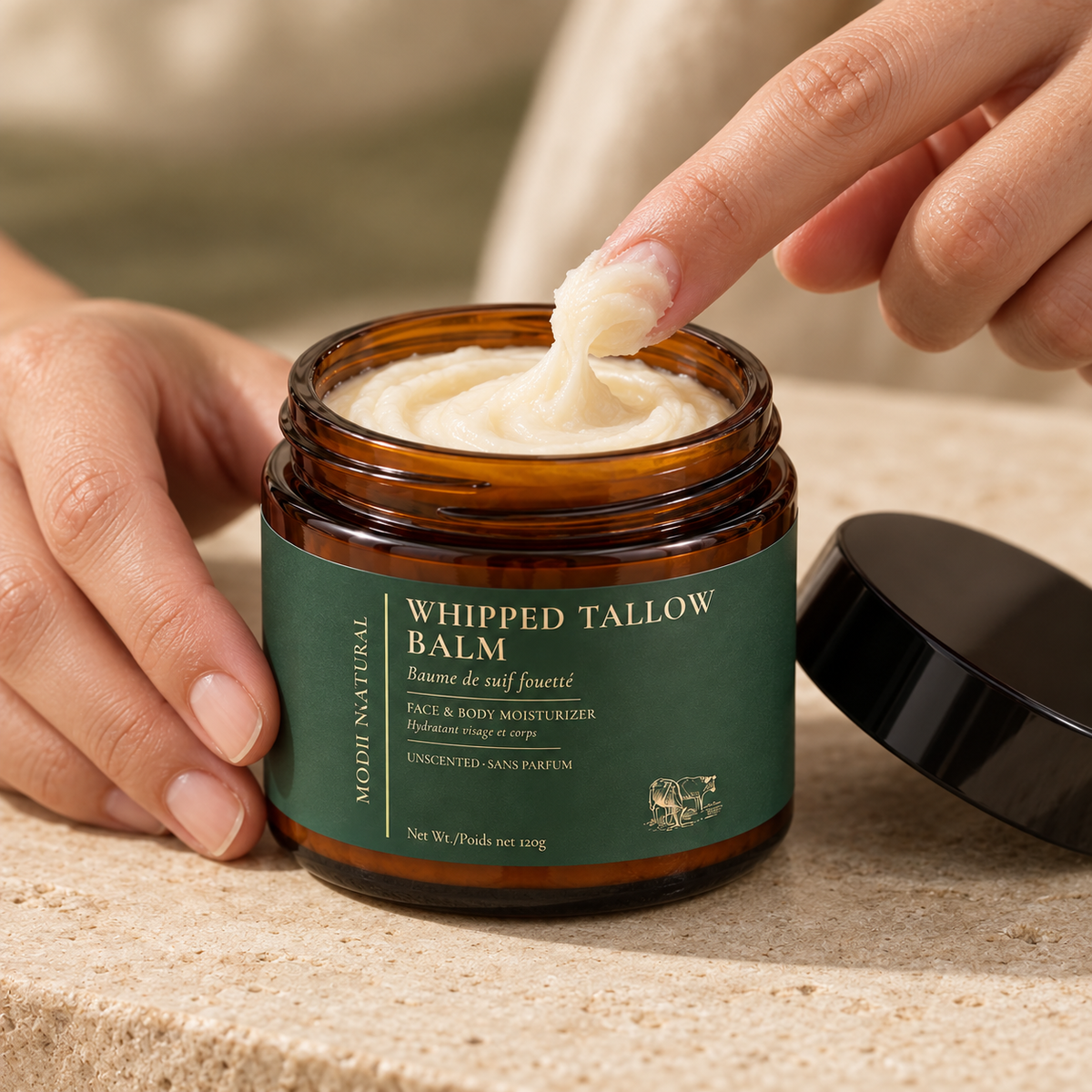 MODII Natural Whipped Tallow Balm - 120g — a small amount prepared on adult fingertips before application